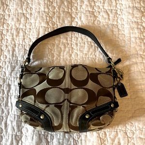 Coach Canvas Mini Bag with Signatura Logo “C”s. Leather Rivited Straps Accents.